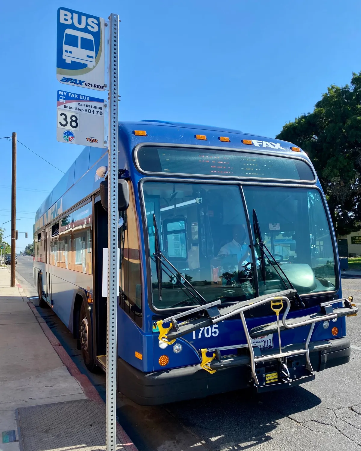 A FAX bus pulled up at a neighborhood bus stop